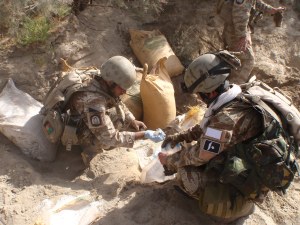 Two Bost 170 operators take chemical samples from the largest find ever made in Helmand